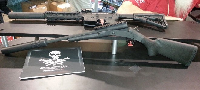 The Handi-rifle is in the foreground shown with an AAC Silencer.  An AR-15 in the background.