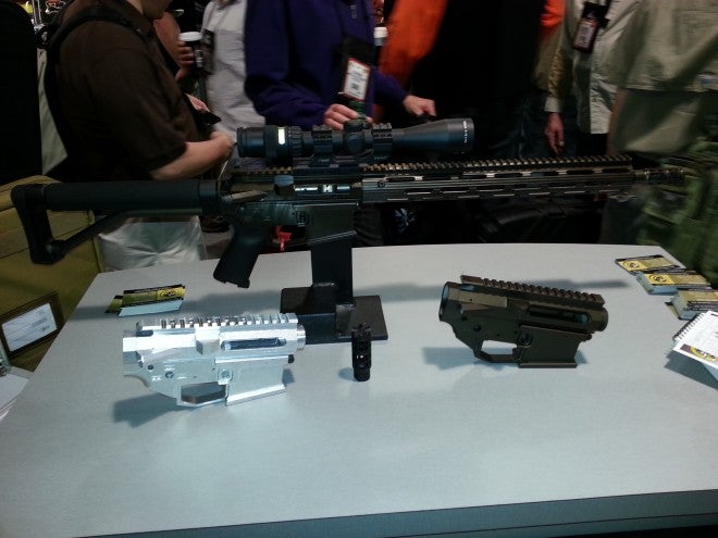 Shown here is their 3-gun model, two of their lowers, and a muzzle brake.