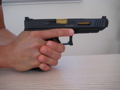 All the support hand fingers are wrapped around the shooting hand.