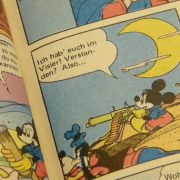 Donald Duck going agro with a Tommy gun and a revolver.