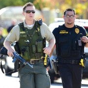 Police at the scene of a shooting on December 2, 2015 in San Bernardino, California. One or more gunman opened fire inside a building in San Bernardino in California, with reports of 20 victims at a center that provides services for the disabled. Police were still hunting for the shooter, saying one to three possible suspects were involved. Heavily armed SWAT teams, firefighters and ambulances swarmed the scene, located about an hour east of Los Angeles, as police warned residents away.  AFP PHOTO / FREDERIC J. BROWN / AFP / FREDERIC J. BROWN        (Photo credit should read FREDERIC J. BROWN/AFP/Getty Images)