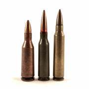 A 5.45x39mm 7N6 cartridge, flanked by two of its predecessors. The 5.6x39mm (left) was developed from an early Soviet ballistic test round using the 7.62x39mm case head, which was designed to duplicate the performance of the early .222 Remington Special (right), later renamed the .223 Remington.