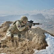 A British Army soldier provides overwatch with his L129A1 rifle in Afghanistan. Image source: reddit