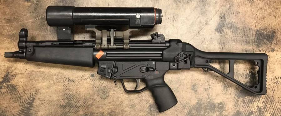 http://www.thefirearmblog.com/blog/wp-content/uploads/2017/03/old-school-hk-optic-made-by-hensoldt-that-projects-light-with-a-crosshair-in-the-beam-it-runs-on-5-c-batteries-and-weighs-as-much-as-the-mp5-itself-2.jpg