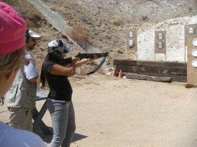 A new shooter with an FNH FLP MK1 shotgun. Supervising next to her is club member and NRA Certified Instructor Steve Haehnichen.