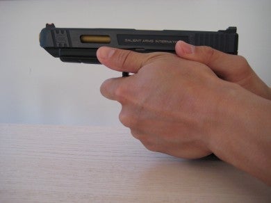 Notice the support hand is forward of the trigger guard.