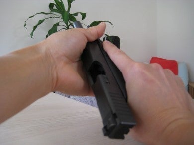 Charging a semi-auto pistol by grasping the slide near the muzzle, and "pinching" the slide in between your thumb and pointer finger.