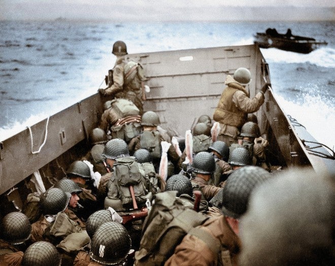 Some of the first American soldiers to attack the German defenses in Higgins Boats (LCVPs) approach Omaha Beach near Normandy, France on June 6, 1944. Plastic covers protect the soldier's weapons against from the water.  (Photo by Robert F. Sargent, U.S. Coast Guard/Galerie Bilderwelt/Getty Images)