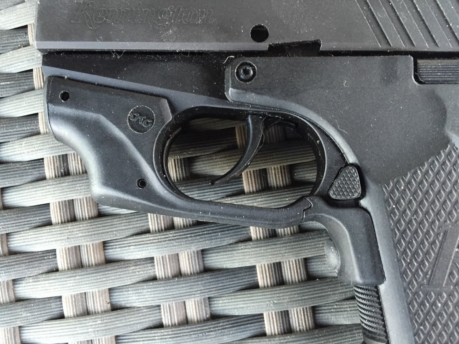 This shows the activation button and fit of the laser. The right side magazine release is also seen. The pistol has true ambi magazine releases