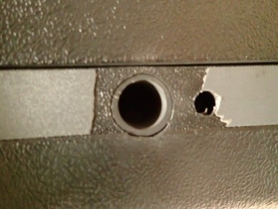 The trim has flaked off near the firing port, due to muzzle blast.