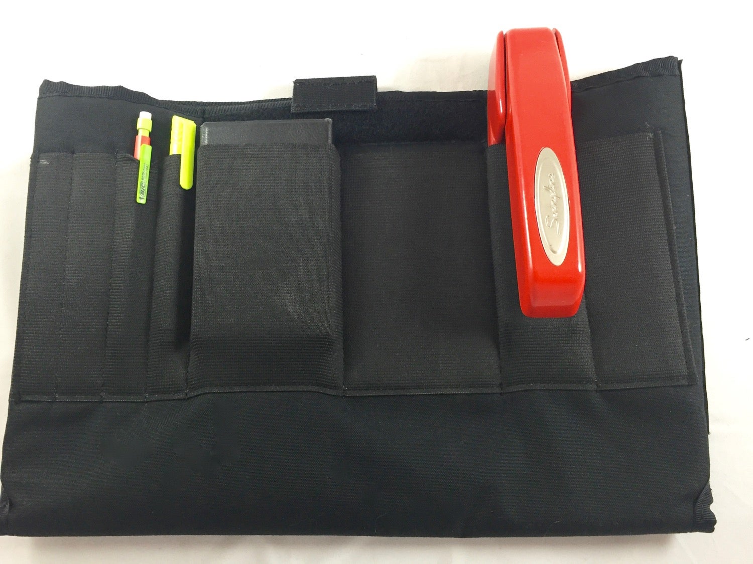 Elastic loops for holding pens, pencils, small rectangularish thingies, and Red Swingline Model 747 staplers.