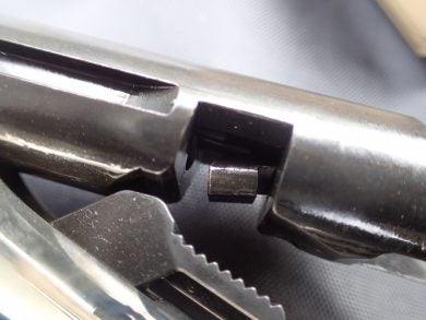 rear portion of 2-part firing pin in the bolt. Note texturing on hammer below.