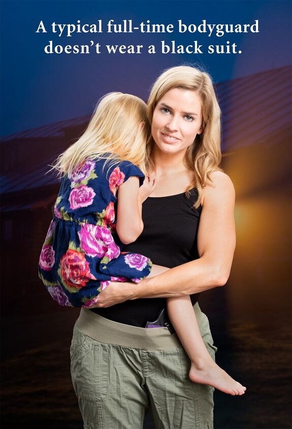 Woman holding child with gun in her waistband