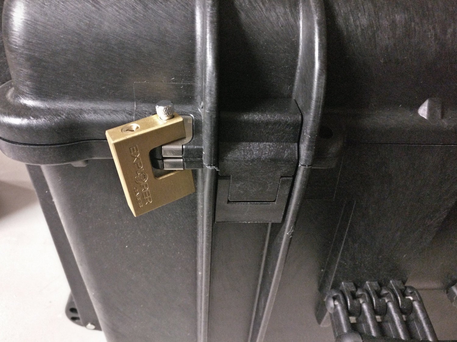 Brass keyed padlock affixed to metal hasp