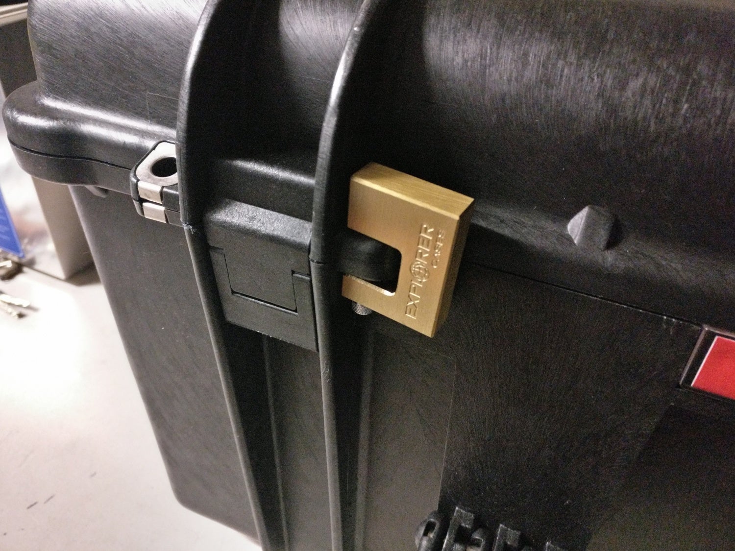 Brass keyed padlock affixed to a plastic hasp