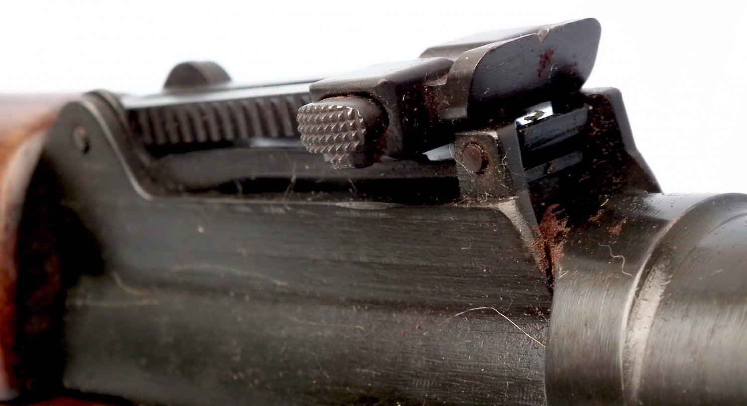 The same gun’s adjustable ramp notch rear sight. It can be noticed that no range adjustment markings are present.