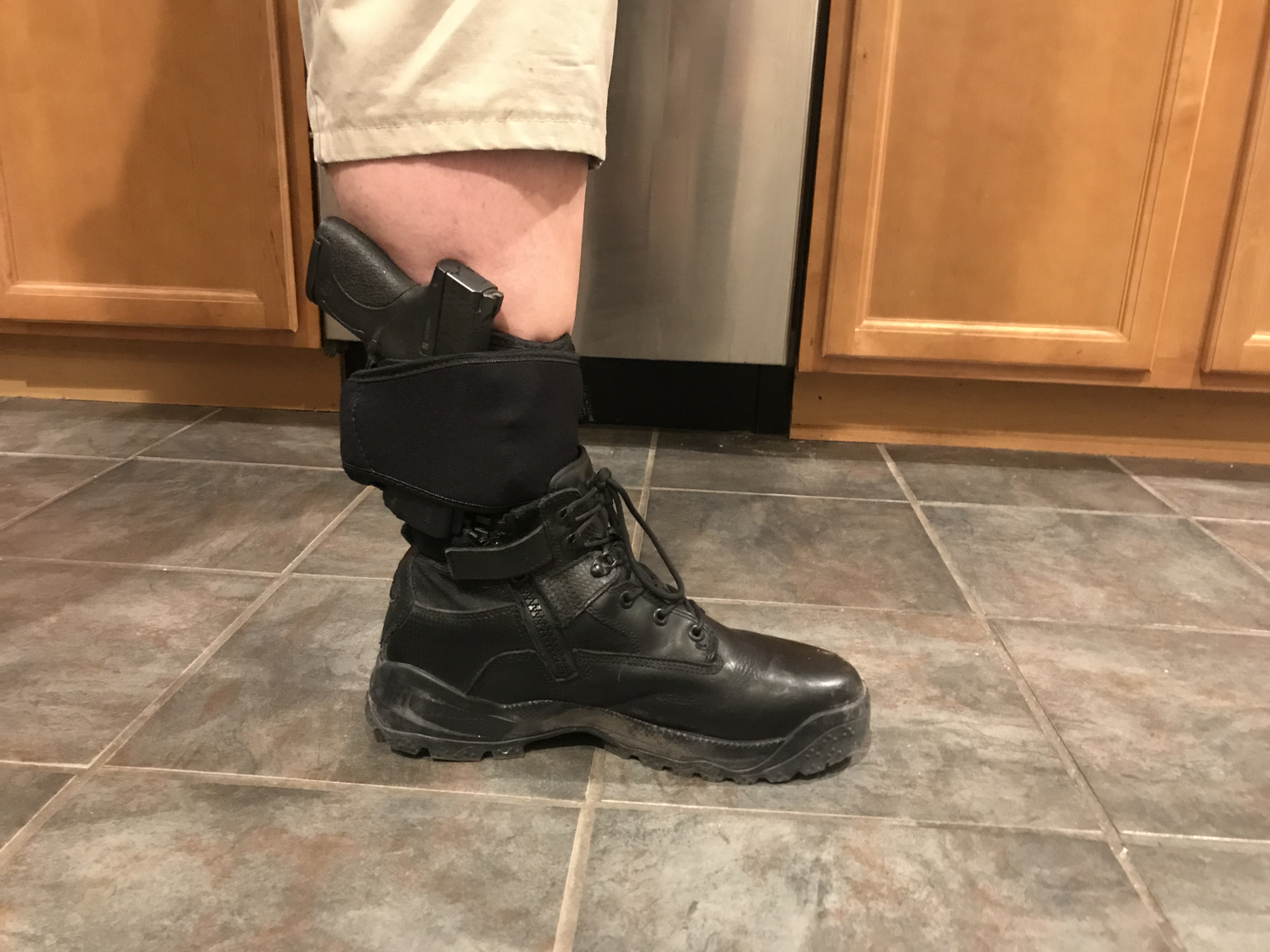 Holster exposed. It is at the highest setting and rests on the top of the boot. You might be able to run it with a higher boot, but you would certainly NOT be able to use the lower wrap.