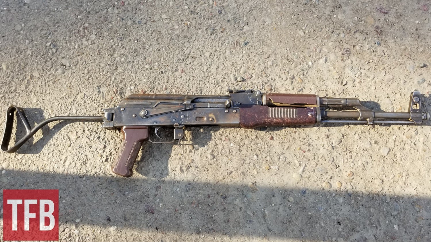 Typical workhorse East German AK with rust and chipped handguard.