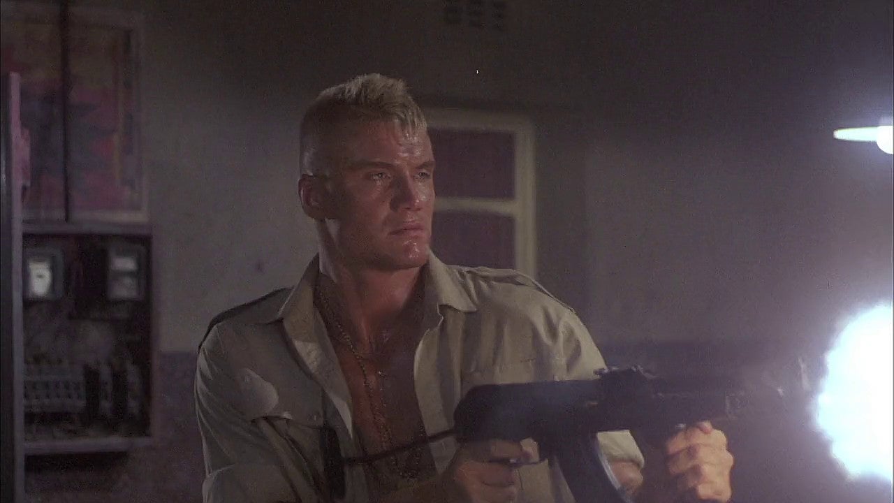 Dolph Lundgren in the movie "Red Scorpion", wreaking havoc in the bar with his AMD-65
